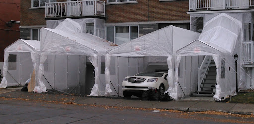 A few utility shelters in front of buildings